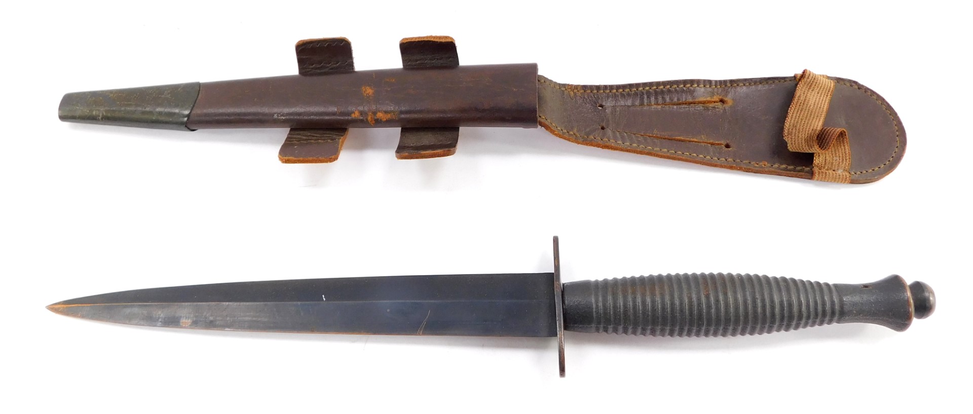 A Fairbairn Sykes Commando knife, with a foiled grip, leather sheath, 31cm high.