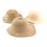 A 1942 tropical sun helmet, together with two others. (3)