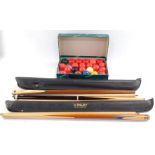 Two Riley snooker cues, Pot Black snooker cue and Aramith Beer balls, boxed.