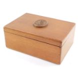 A carved wooden box with Scottish Regimental carving to top, label under Made By Men Of The Royal Na