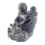 A Wolf Inuit sculpture of a seated mother and child, bears label, 14cm high.
