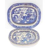 Two graduated Victorian blue and white Willow pattern pottery meat plates, 55cm and 45cm.