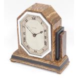 A 1930s Art Deco golden onyx mantel clock, with black onyx banding, the dial marked Swinden, Birming