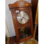 A Continental wall clock, in oak case, dial stamped eight days striking.