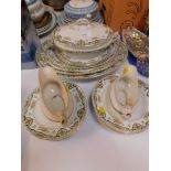 A late 19thC pottery part dinner service, including meat platters, vegetable tureen and cover, gravy