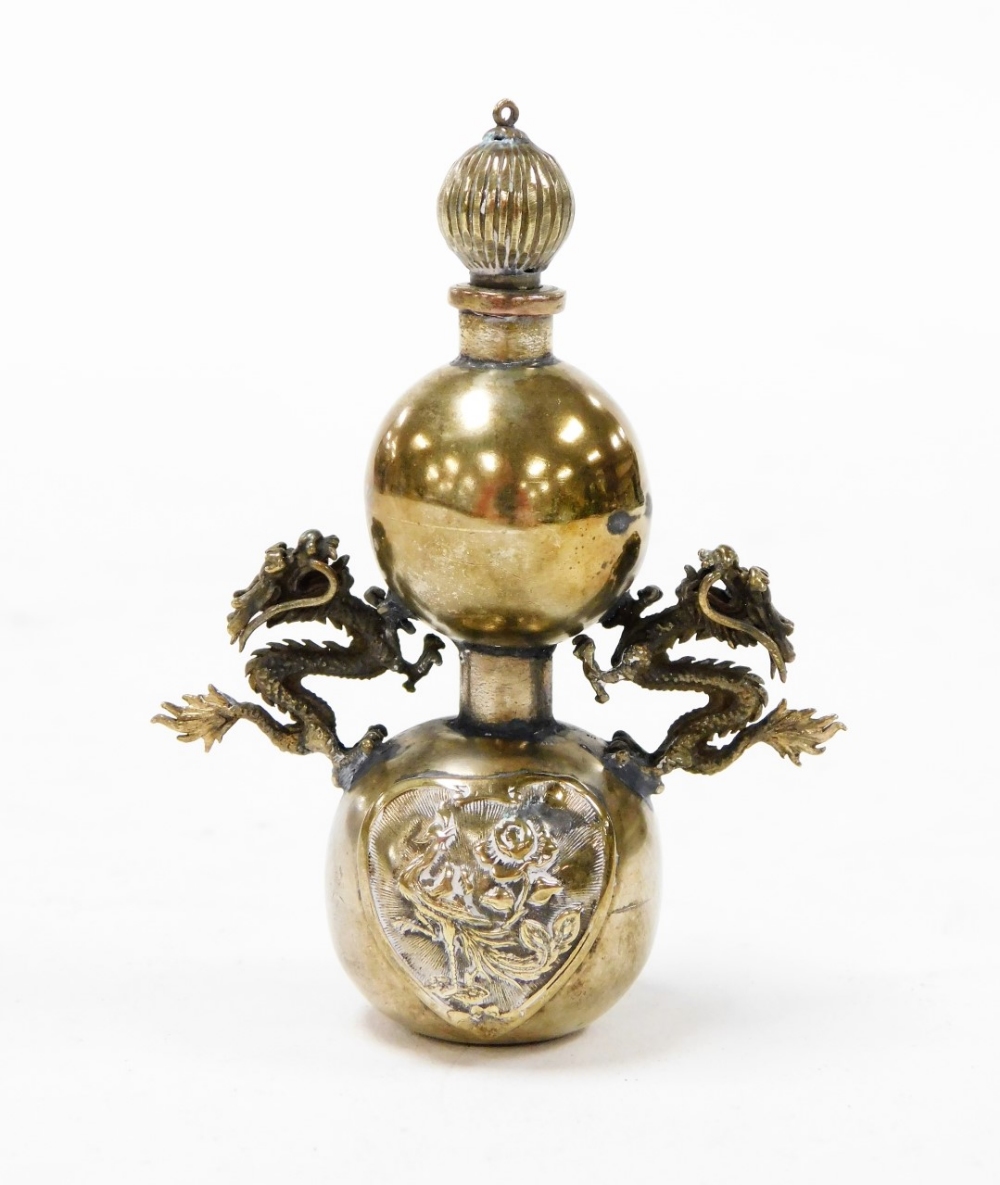 A Chinese bronze opium bottle, with integral spoon stopper, dragon mounts and cast body to the lower