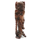 A carved hardwood figure of an Eastern gentleman, 30cm high.