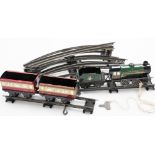 A tin plate clockwork Hornby train, with three carriages, two no. 9798, the other British Railways,