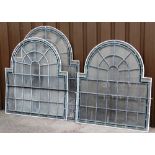 Three panels of stained leaded glass arches, each with a square base with arched top, with single gr