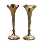 A pair of George V silver bud vases, each with fluted stem on a weighted base, London 1921, 14cm hig