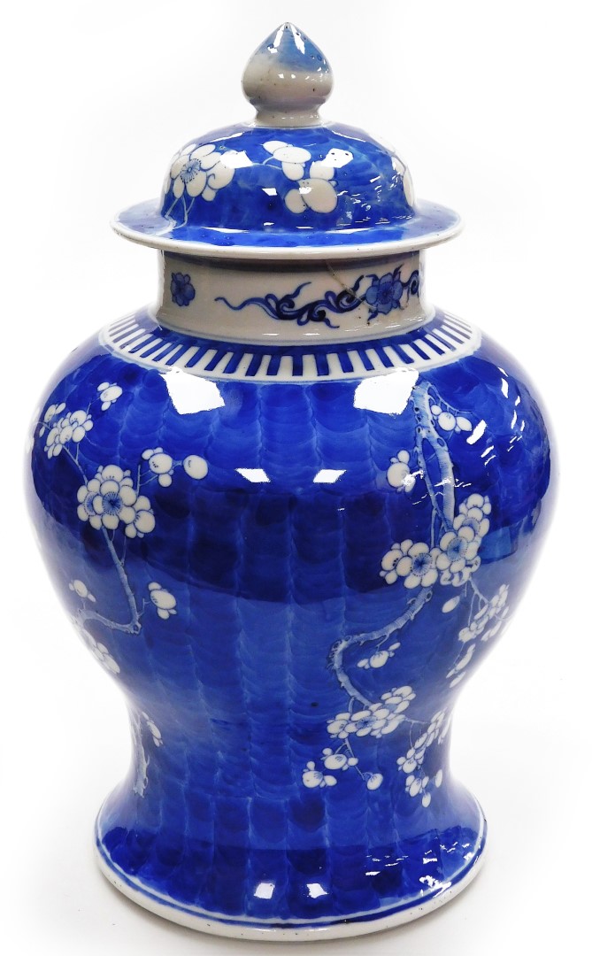 A large Chinese blue and white vase and cover, decorated with prunus blossom decoration with four ch