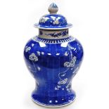 A large Chinese blue and white vase and cover, decorated with prunus blossom decoration with four ch