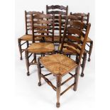 Six rush seated and oak framed dining chairs, to include one carver, each with five panelled back. (