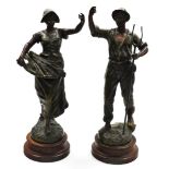 A pair of 19thC French bronze patinated spelter figures, being a gentlemen and a lady carrying wheat