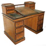 A Victorian oak banker's desk, with ebonised mouldings to the raised upper section and the drawer co