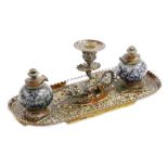 A 19thC continental brass ink stand, with central dragon taperstick and two stoneware inkwells each