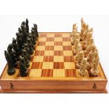 An oriental resin chessboard and chess pieces, the pieces each of oriental figures in white and gree