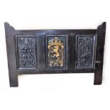 A black painted headboard, with three panel decoration, the central panel with lion motif in gilt pa