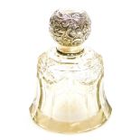 A George V silver and pressed glass dressing table jar, the silver top with embossed floral detailin