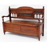 A late Victorian walnut settle, with galleried scroll back and fluted column supports, 96cm high, 13