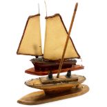 Two wooden Art Deco model boats, converted to lamps, 47cm high, 54cm high.