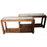 Two modern hardwood Chinese style hall tables, each with a glass inset top with brass surrounds and