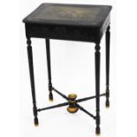 A 19thC French parcel gilt and ebonised work table, with en grisaille painted top of cherubs, and ro