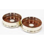 A pair of silver wine coasters, each with wooden base and silvered rim, Birmingham Millennium 2000,