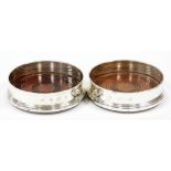 A pair of silver and wooden wine coasters, the oak ribbed bases with velvet cushioned stopper, Birmi