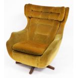 A vintage Parker Knoll Blofeld type model 1028 Statesman swivel chair, in a yellow draylon, with but