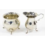 A George V Mappin & Webb silver sugar bowl and milk jug, with wavy rim, each on three feet, London 1