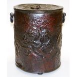 An Arts and Crafts coal bucket, in an ebonised copper finish design of heads of dragons, with two sw