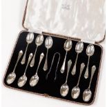 A George V cased set of silver teaspoons and sugar nips, each bearing the initial C, comprising twel