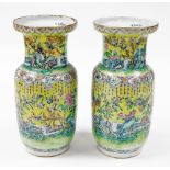 A pair of 19thC Chinese porcelain baluster vases, each heavily decorated with birds and flowers, on