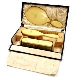 A Harrods of London ivorine dressing table set, comprising mirror, two brushes and a comb, each insc