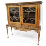 A 19thC oak cabinet bookcase, the drop design top above two astragal glazed doors on sideboard base