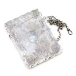 A Victorian silver card case, with chased detailing, vacant cartouche and carry chain, Birmingham 18