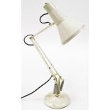 A cream angle poise lamp, 85cm high when fully extended.