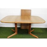 A Skovby Danish teak extending dining table, with two additional leaves, 72cm high, 100cm long,