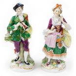 Two Continental porcelain figures, depicting a lady and gentleman each elaborately dressed, with enc