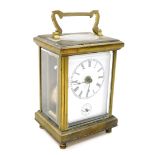 A late 19thC brass carriage clock, with white enamel dial and seconds dial, key wind 11cm high.