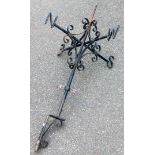 A wrought iron weather vane, with spiral supports, 95cm high.