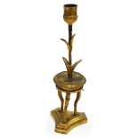 A 19thC French ormolu candlestick, gilt decorated with a palm leaf stem, on a circular console table