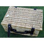 A wicker picnic basket and contents to fill.