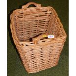 A wicker basket with carrying handles.