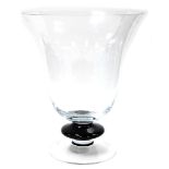 A large glass goblet shaped vase, on a black stem, 50cm high, 41cm wide.