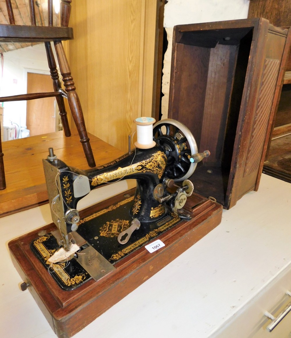 A cased Singer hand sewing machine, number 823723.