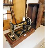 A cased Singer hand sewing machine, number 823723.