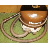 A vintage Henry numatic vacuum cleaner in brown.