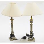 A pair of silvered finished table lamps, each with cream shade.